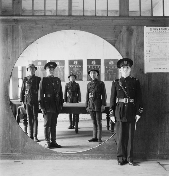 Assistant Chief of Police and his staff at the Headquarters in Chengtu, 1944. This photograph was taken by the well known war photographer Cecil Beaton.