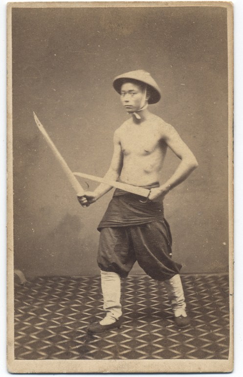 1860s photograph of a "Chinese Soldier" with butterfly swords. Subject unknown, taken by G. Harrison Grey.