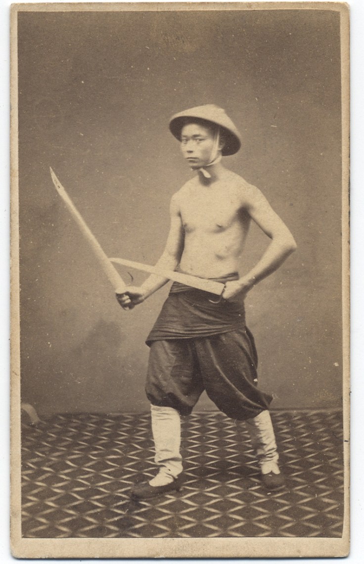 1860s photograph of a "Chinese Soldier" with butterfly swords. Subject unknown, taken by G. Harrison Grey.