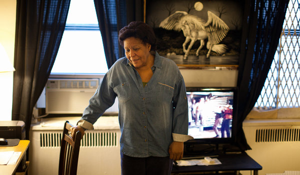 Alejandrina Cruz at her apartment in the Bronx, Kung Fu film playing in the background. Source: New York Times.