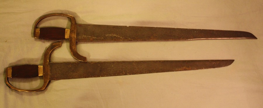 These swords embody elements of both the longer copping ans stabbing types that were popular in the 19th century. Both blades are finely made, well balanced and exhibit long false edges. Total length: 60 cm; Width at bade: 5 cm, width of spine: 10 mm. Source: Author's Personal collection.