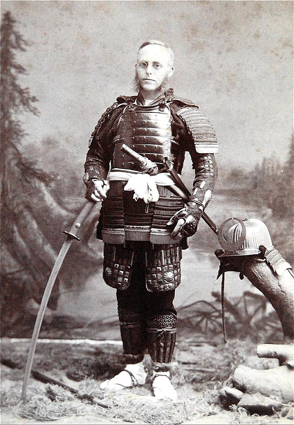 A tourist posing with Japanese weapons, circa 1890. Photographer unknown.