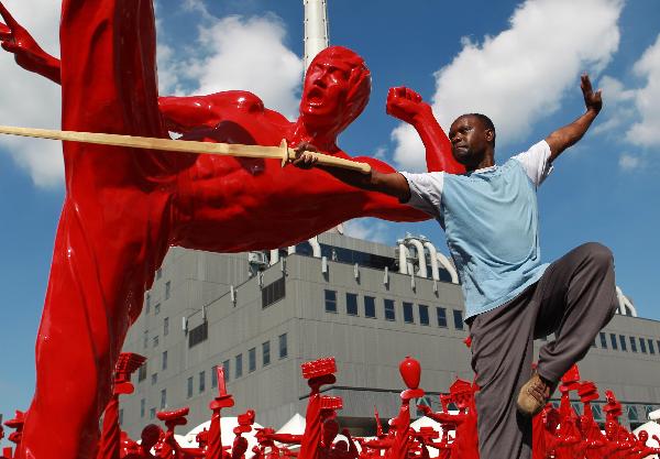 Luc Bendza in front of a state of Bruce Lee in Shanghai.  Bendza immigrated to China to study Kung Fu over 30 years ago and is now a figure in the local film industry.