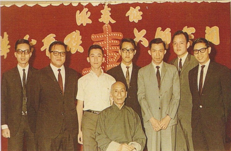 Ho Leun standing to the left of Ip Man. Source: Ip Ching and Ron Heimberger. Mook Yan Jong Sum Fat. 2004.