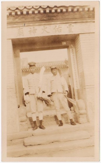Dadaos held by two soldiers in front of a temple in Beijing.  Source: Author's personal collection.