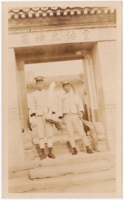 Dadaos held by two soldiers in front of a temple in Beijing.  Source: Author's personal collection.