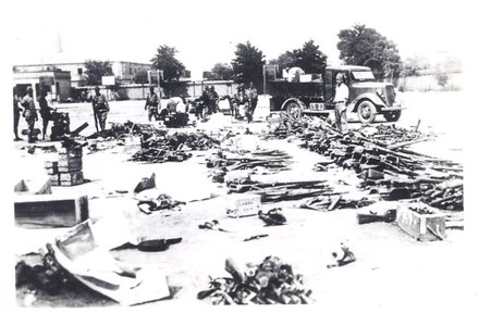 A yard in which captured Chinese weapons and material is being sorted by Japanese soldiers.  Source: Author's personal collection.
