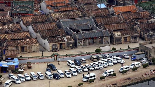 Police vehicles parked outside of the walls of    Source: Reuters.