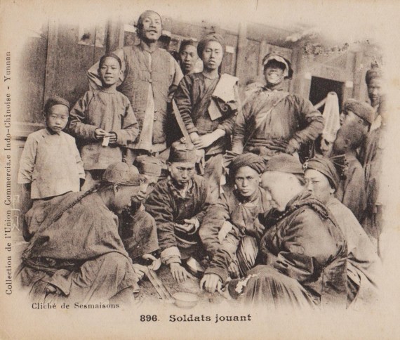 Image taken from a vintage french postcard showing soldiers gambling in Yunnan province.  Note that the standing soldier on the left is holding a hudiedao in a reverse grip.  Source: Author's personal collection.