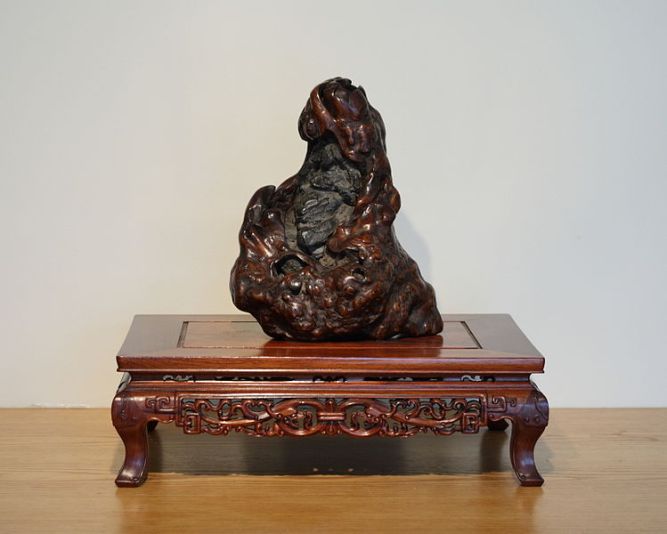 A viewing stone said to look like the famous monk Bodhidharma (often associated with the Shaolin Temple).  Stones like this are collected and appreciated by individuals in both China and Japan.  This particular specimin is located in the National Bonasai and Penjing Museum in Washington D.C.  Source: Photo by Sage Ross, Wikimedia.