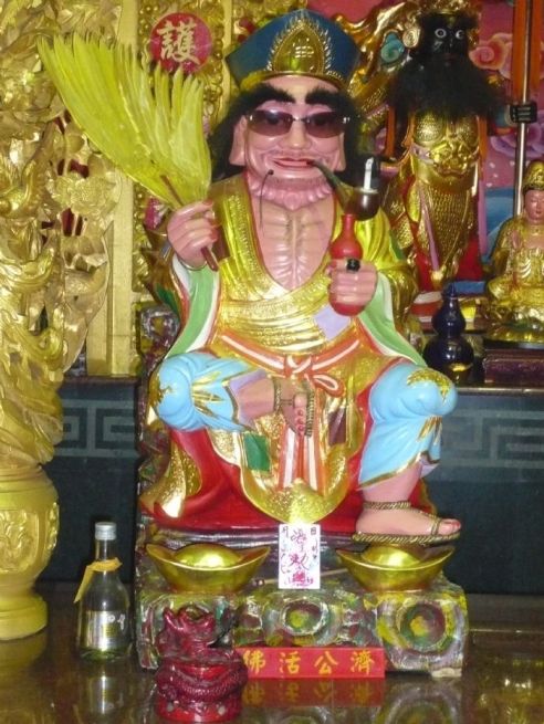 A modern votive statue of Ji Gong.  I love the updated look with the Sunglasses.