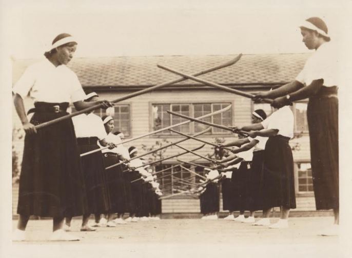 A press photo issued by the Japan Press Illustrated Service. The caption on the back reads "Instruction of Halbert and Sword.---The halbert has been instructed from old as a peculiar Japanese military art of women that trains them spiritually at the same time according to then spirit of chivalry. Photo shows girls of the Fifth girls high school of Tokyo practicing the art. (Copyrighted 231). JPI Photos." Source: Author's personal collection.