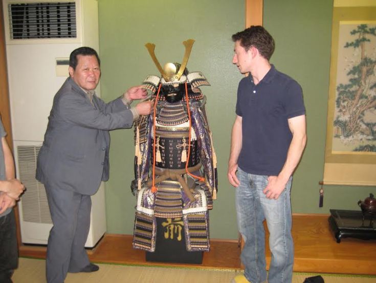 Dr. Miracle examining a set of traditional Japanese armor. Source: The collection of Dr. Jared Miracle.