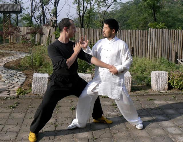 Master Chen Zhonghua and Daniel Mroz playing Tui Shou, Daqingshan, Shandong, China, 2007. Photo by Scot Jorgensen.