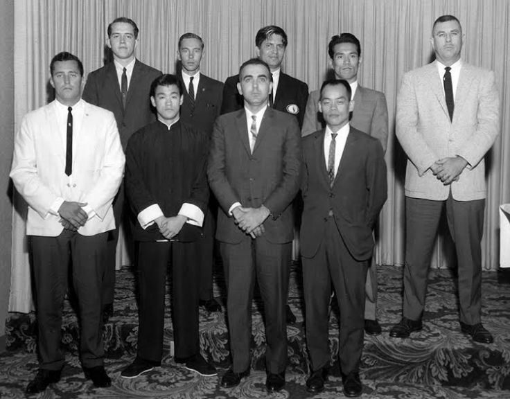 Long Beach: "He just started trashing people." A young Bruce Lee, bottom row second from left, standing with other presenters at Ed Parker's inaugural Long Beach International Karate Tournament in the summer of 1964. J. Pat Burleson, Bruce Lee, Anthony Mirakian, Jhoon Rhee. Back Row, Left to Right: Allen Steen, George Mattson, Ed Parker, Tsutomu Ohshima, Robert Trias. Source: Photo courtesy of Darlene Parker.